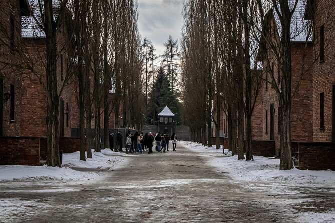 Auschwitz Birkenau Tour from Krakow: Private Transfer + Ticket - Auschwitz I and the gate with its infamous inscription